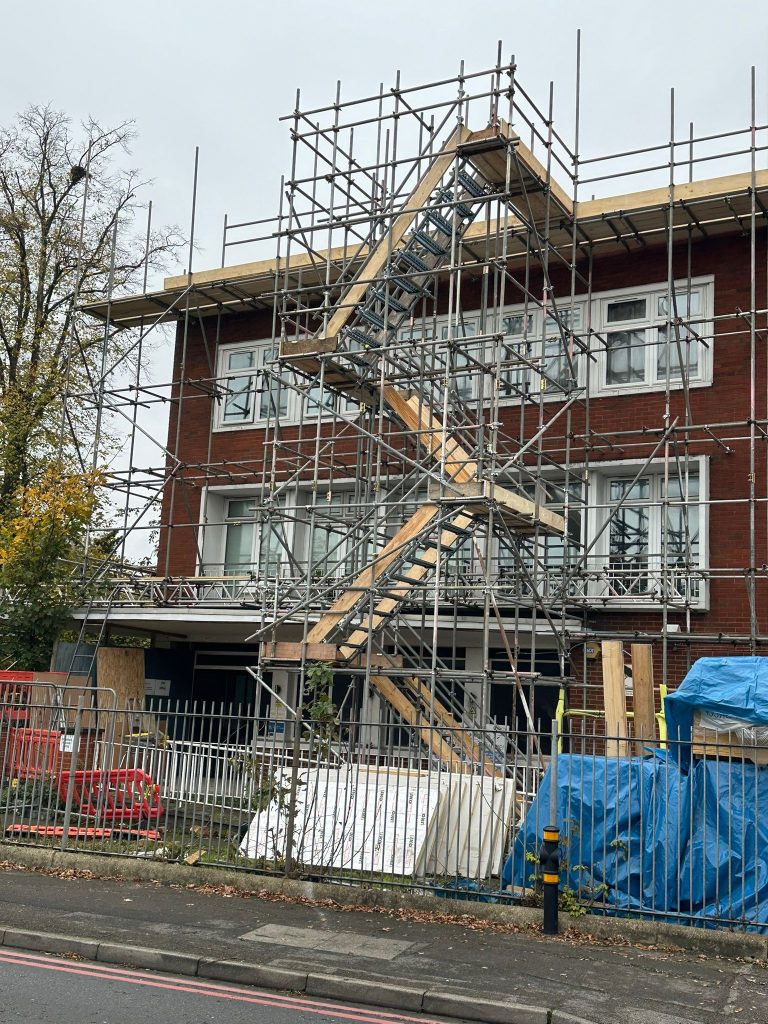Scaffolding hire with Haki staircase providing safe access on a multi-storey building in London