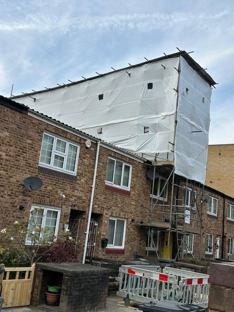 Temporary roof scaffolding hire providing weather protection to a residential building in London